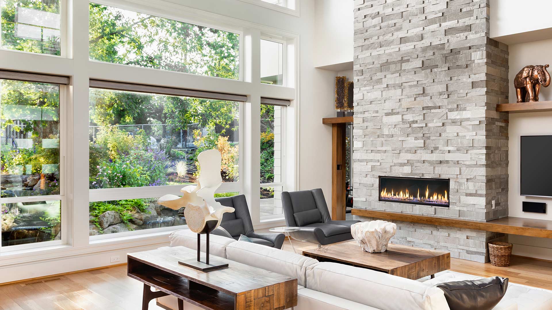 living room with large windows and fireplace taylorsville ut